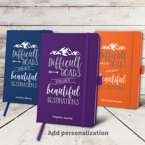 blue, purple, and orange hardbound journals with Beautiful Destinations message and personalization