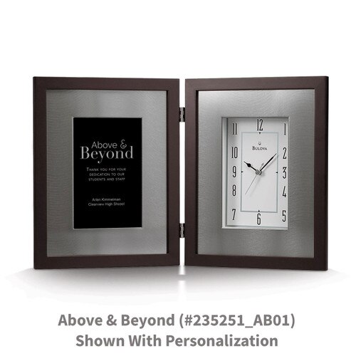 large framed clock with above and beyond message