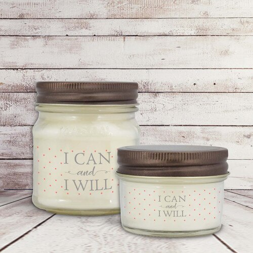 two white candle in glass jar with i can and i will message