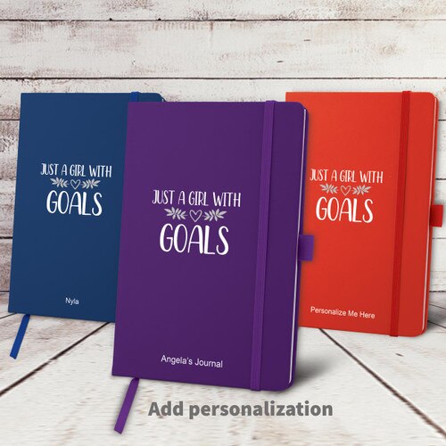 blue, purple, and red hardbound journals with Just A Girl With Goals message and personalization